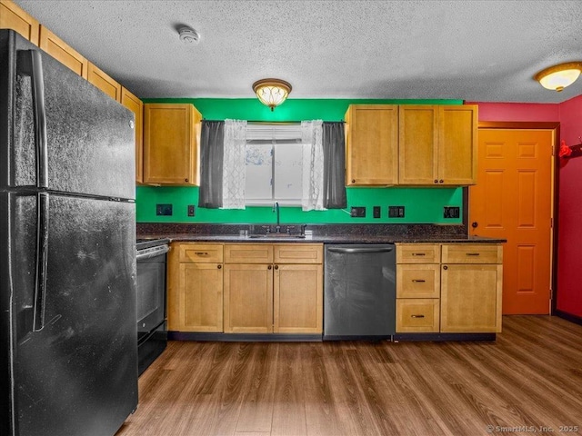 1081 New Haven Rd Apt 12F, Naugatuck, CT 06770 - kitchen with black appliances, dark wood-style floors, a sink, a textured ceiling, and dark countertops