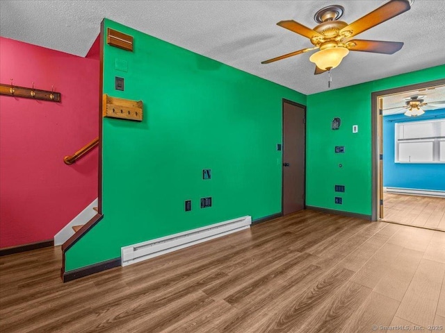1081 New Haven Rd Apt 12F, Naugatuck, CT 06770 - spare room featuring baseboard heating, wood finished floors, a textured ceiling, ceiling fan, and baseboards