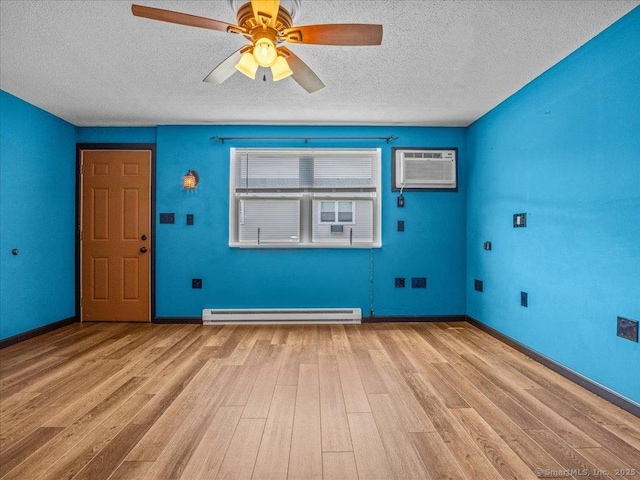1081 New Haven Rd Apt 12F, Naugatuck, CT 06770 - foyer featuring a baseboard heating unit, an AC wall unit, a textured ceiling, wood finished floors, and a ceiling fan