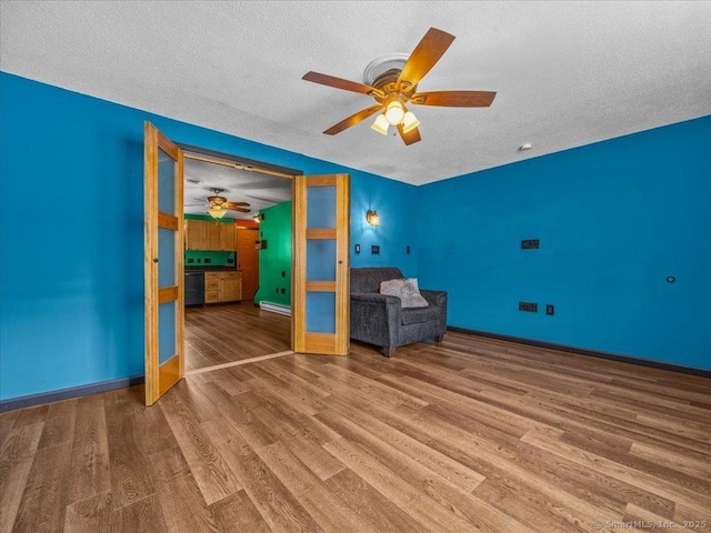 1081 New Haven Rd Apt 12F, Naugatuck, CT 06770 - unfurnished bedroom featuring a textured ceiling, wood finished floors, baseboards, and ceiling fan