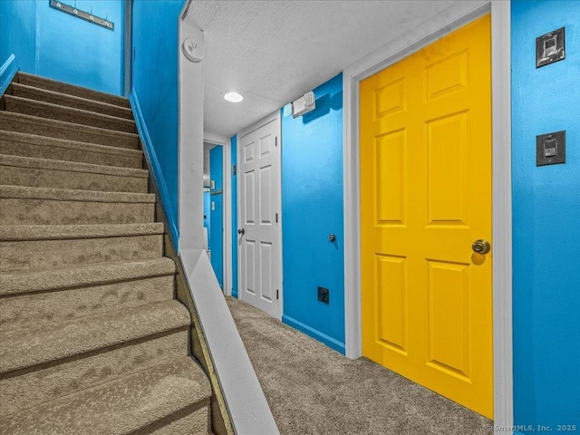 1081 New Haven Rd Apt 12F, Naugatuck, CT 06770 - stairway featuring carpet, a textured ceiling, and baseboards