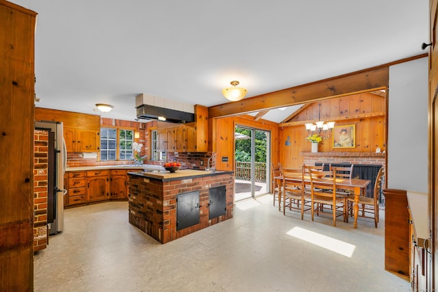 171 Still Rd, West Hartford, CT 06117 - kitchen with wooden walls, wall chimney exhaust hood, light countertops, brown cabinetry, and lofted ceiling