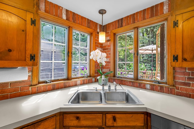 171 Still Rd, West Hartford, CT 06117 - kitchen featuring light countertops, healthy amount of natural light, pendant lighting, and brown cabinets