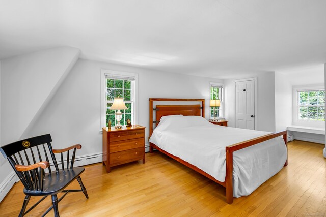 171 Still Rd, West Hartford, CT 06117 - bedroom with light wood-type flooring, a baseboard heating unit, and vaulted ceiling