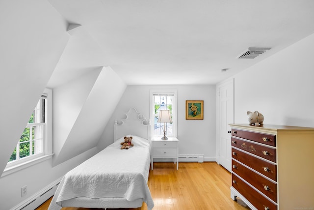 171 Still Rd, West Hartford, CT 06117 - bedroom with baseboard heating, multiple windows, light wood-type flooring, and vaulted ceiling
