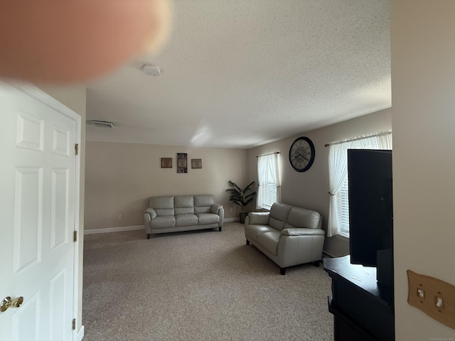 24 Podunk Cir Unit 24, South Windsor, CT 06074 - living area featuring light carpet and a textured ceiling