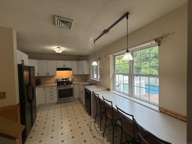 24 Podunk Cir Unit 24, South Windsor, CT 06074 - kitchen with black appliances, ventilation hood, light countertops, white cabinetry, and a textured ceiling