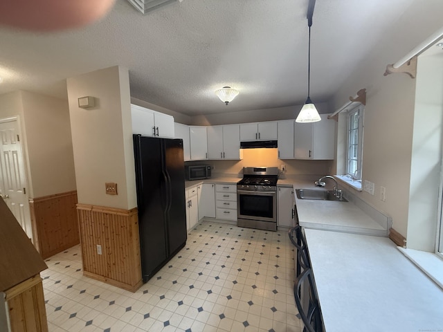 24 Podunk Cir Unit 24, South Windsor, CT 06074 - kitchen with black appliances, under cabinet range hood, wainscoting, light countertops, and white cabinetry