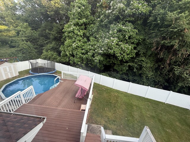 24 Podunk Cir Unit 24, South Windsor, CT 06074 - view of pool with a fenced backyard, a deck, and a storage shed