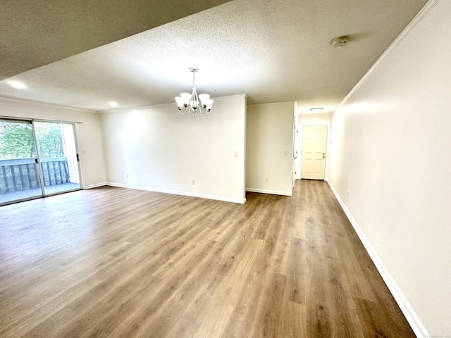1 Concorde Way Unit B3, Windsor Locks, CT 06096 - empty room featuring a chandelier, baseboards, a textured ceiling, wood finished floors, and a smoke detector
