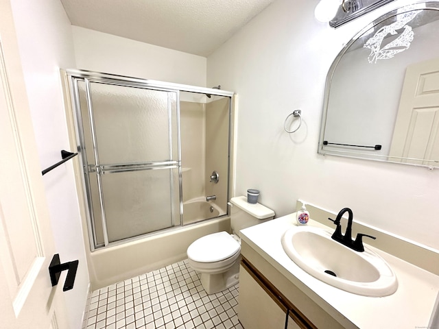 1 Concorde Way Unit B3, Windsor Locks, CT 06096 - bathroom with vanity, toilet, bath / shower combo with glass door, tile patterned flooring, and a textured ceiling