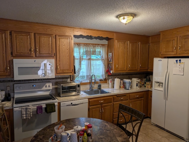 190 Sunnydale Ave, Bristol, CT 06010 - kitchen with white appliances, a sink, brown cabinetry, a textured ceiling, and light tile patterned floors