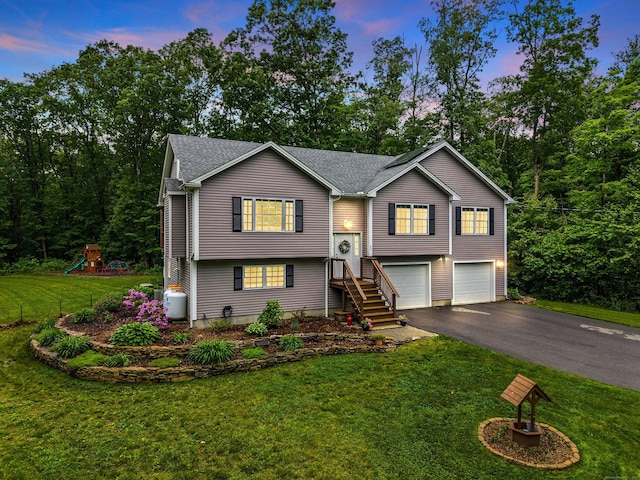 43 Old Young St, East Hampton, CT 06424 - split foyer home featuring an attached garage, driveway, roof with shingles, and a front lawn