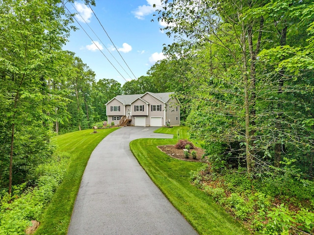 43 Old Young St, East Hampton, CT 06424 - bi-level home featuring asphalt driveway, a garage, and a front yard