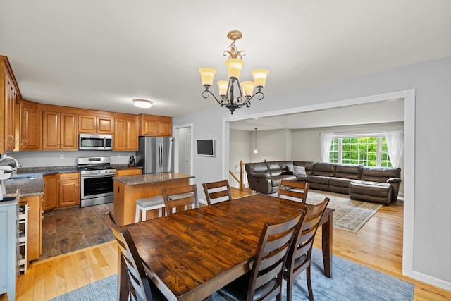 43 Old Young St, East Hampton, CT 06424 - dining space featuring a chandelier and wood finished floors