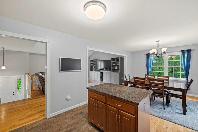 43 Old Young St, East Hampton, CT 06424 - kitchen with a chandelier, pendant lighting, a kitchen island, dark stone counters, and brown cabinetry