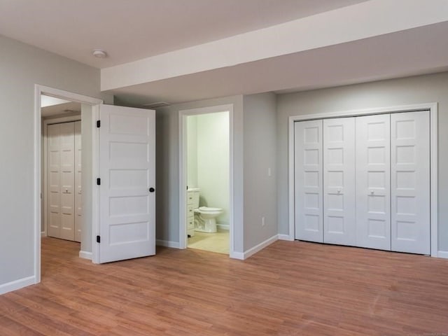 12 S St, Brooklyn, CT 06234 - unfurnished bedroom featuring light wood finished floors, baseboards, a closet, and ensuite bath