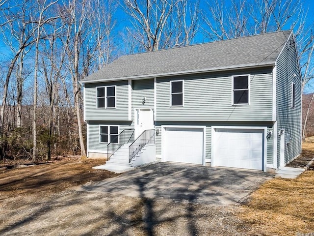 12 S St, Brooklyn, CT 06234 - split foyer home featuring asphalt driveway, roof with shingles, and a garage