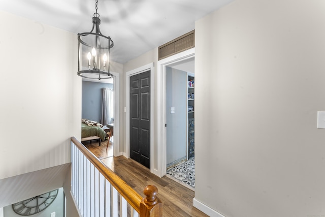 6 Mountain Laurel Ct Unit 6, Cromwell, CT 06416 - hallway with wood finished floors, a chandelier, and baseboards