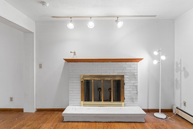 120 Pulaski Hwy, Ansonia, CT 06401 - detailed view of a baseboard heating unit, wood finished floors, a brick fireplace, and a smoke detector