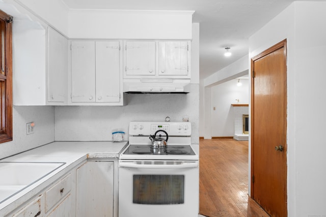 120 Pulaski Hwy, Ansonia, CT 06401 - kitchen with white electric range oven, range hood, light countertops, white cabinets, and light wood-style floors
