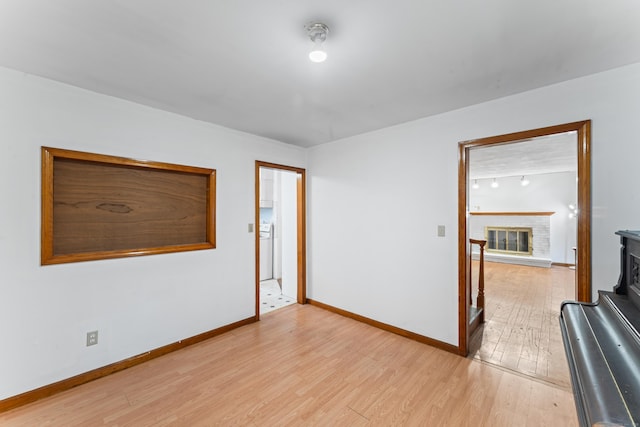 120 Pulaski Hwy, Ansonia, CT 06401 - empty room featuring light wood finished floors and a brick fireplace
