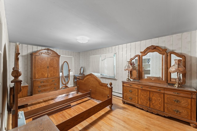 120 Pulaski Hwy, Ansonia, CT 06401 - bedroom with wallpapered walls, a baseboard heating unit, and light wood-type flooring