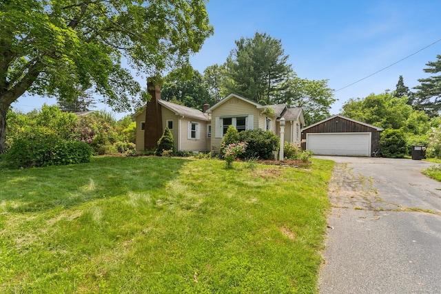 44 Nod Rd, Clinton, CT 06413 - view of front of home with a detached garage, a front yard, and a chimney