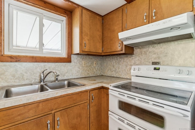 44 Nod Rd, Clinton, CT 06413 - kitchen with electric stove, under cabinet range hood, a sink, brown cabinets, and light countertops