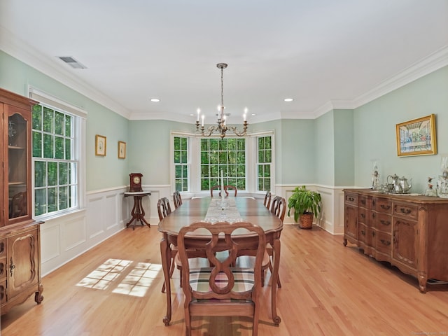 52 Grumman Ave, Wilton, CT 06897 - dining space featuring plenty of natural light, a chandelier, light wood finished floors, a wainscoted wall, and crown molding