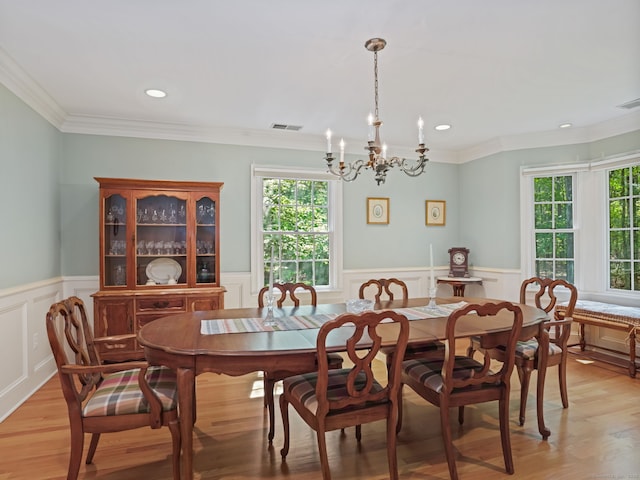 52 Grumman Ave, Wilton, CT 06897 - dining room featuring a chandelier, healthy amount of natural light, light wood-type flooring, a wainscoted wall, and a decorative wall