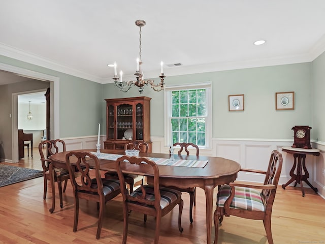 52 Grumman Ave, Wilton, CT 06897 - dining room featuring a chandelier, light wood finished floors, a wainscoted wall, ornamental molding, and a decorative wall