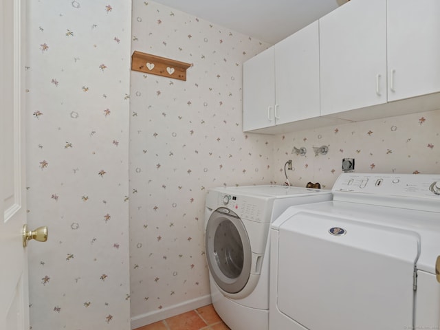 52 Grumman Ave, Wilton, CT 06897 - laundry area with wallpapered walls, washer and clothes dryer, cabinet space, and light tile patterned floors