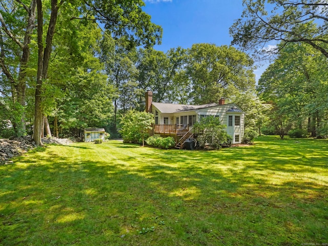52 Grumman Ave, Wilton, CT 06897 - view of grassy yard with a wooden deck, stairway, and an outdoor structure