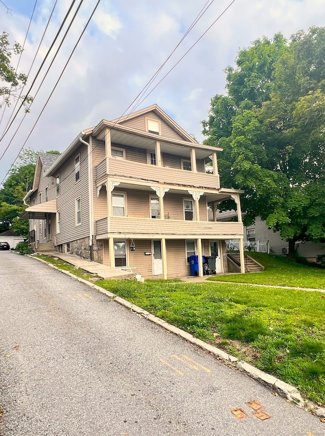 238 E Main St, Torrington, CT 06790 - view of front of house with a front yard, a balcony, and covered porch