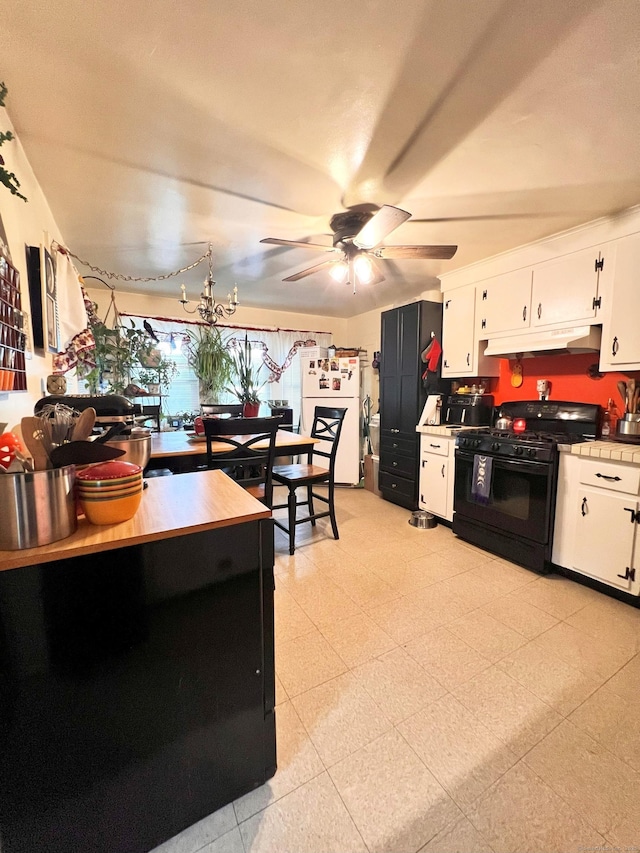 238 E Main St, Torrington, CT 06790 - kitchen featuring black gas range oven, freestanding refrigerator, under cabinet range hood, and white cabinets