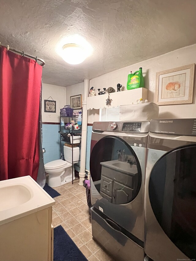 238 E Main St, Torrington, CT 06790 - washroom with washing machine and clothes dryer and a textured ceiling