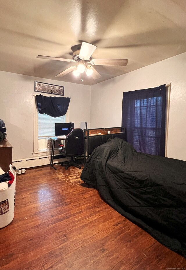238 E Main St, Torrington, CT 06790 - bedroom with wood finished floors, a ceiling fan, a desk, and baseboard heating