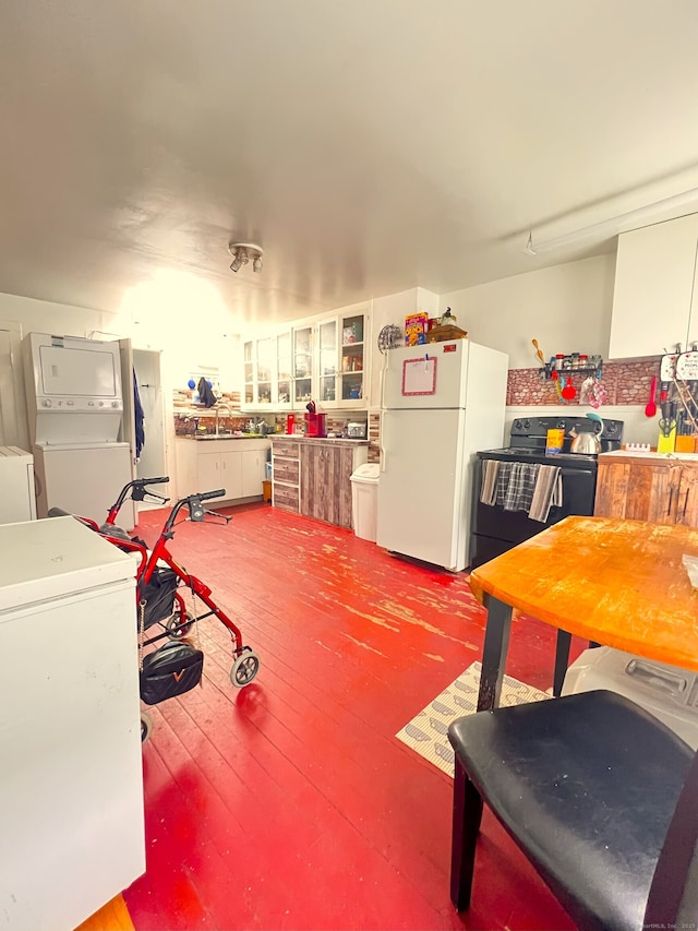238 E Main St, Torrington, CT 06790 - misc room featuring stacked washer and clothes dryer and hardwood / wood-style flooring