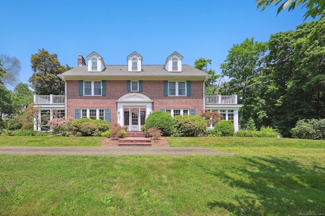 2200 Ridge Rd, North Haven, CT 06473 - georgian-style home with a front lawn, a balcony, and brick siding