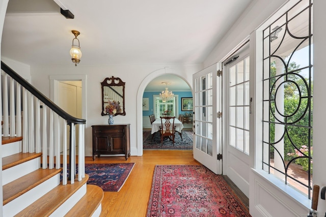 2200 Ridge Rd, North Haven, CT 06473 - entryway featuring arched walkways, stairs, a chandelier, and wood finished floors