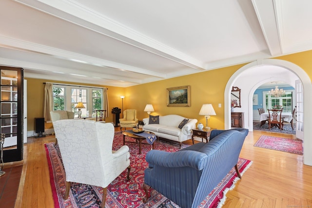 2200 Ridge Rd, North Haven, CT 06473 - living area with arched walkways, beam ceiling, a chandelier, and wood finished floors