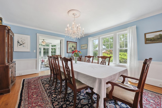2200 Ridge Rd, North Haven, CT 06473 - dining room with wainscoting, ornamental molding, a chandelier, and light wood finished floors