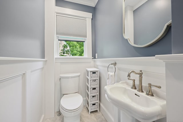 2200 Ridge Rd, North Haven, CT 06473 - bathroom featuring crown molding, wainscoting, and marble look tile flooring