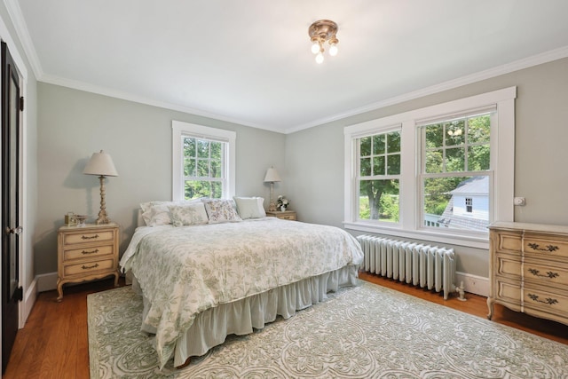 2200 Ridge Rd, North Haven, CT 06473 - bedroom featuring radiator heating unit, wood finished floors, and ornamental molding