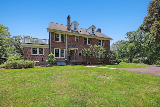 2200 Ridge Rd, North Haven, CT 06473 - view of front of home featuring a chimney, brick siding, a balcony, a front lawn, and entry steps