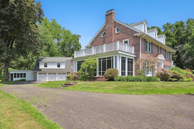 2200 Ridge Rd, North Haven, CT 06473 - view of front of home with a balcony, a chimney, a front lawn, brick siding, and an attached garage