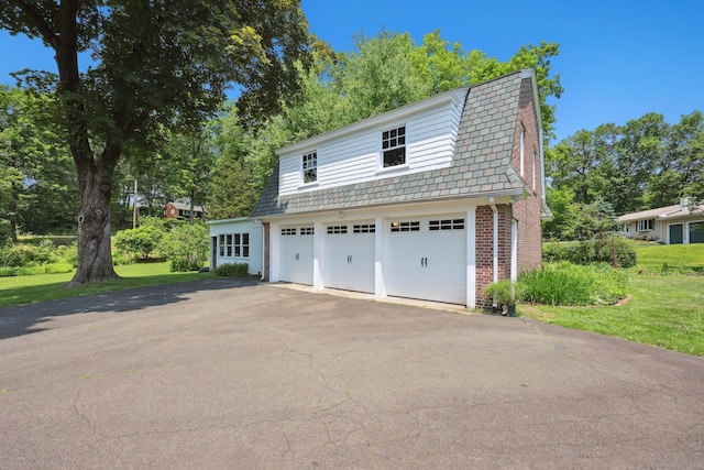 2200 Ridge Rd, North Haven, CT 06473 - view of front of home with a garage, a high end roof, brick siding, driveway, and a front lawn