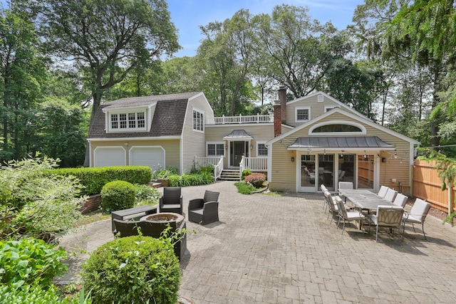 158 Linden Tree Rd, Wilton, CT 06897 - rear view of house featuring a shingled roof, a fire pit, a patio, outdoor dining area, and a gambrel roof