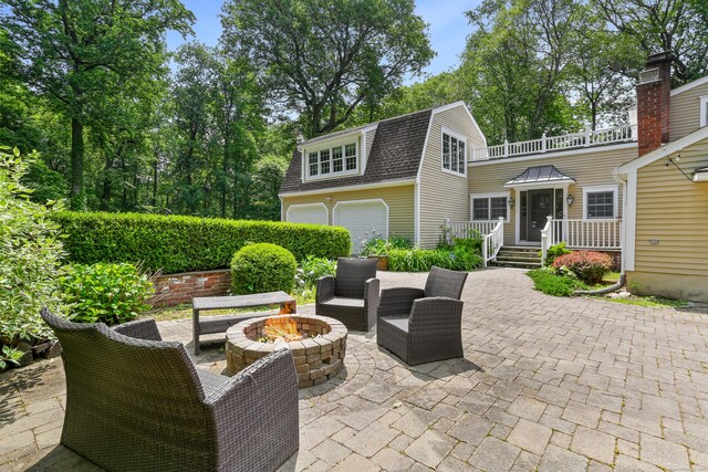 158 Linden Tree Rd, Wilton, CT 06897 - view of patio featuring an outdoor fire pit, a wooden deck, and a garage